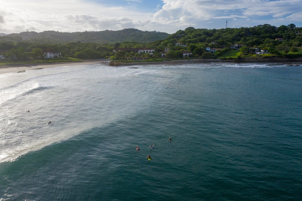 view of surfers in front of the clubhouse of rancho santana