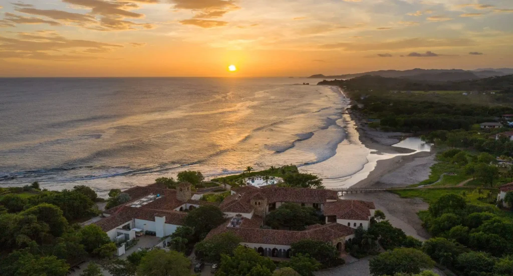 A breathtaking sunset view of Rancho Santana's luxury resort on Nicaragua's Emerald Coast, showcasing its beachfront location and natural beauty."